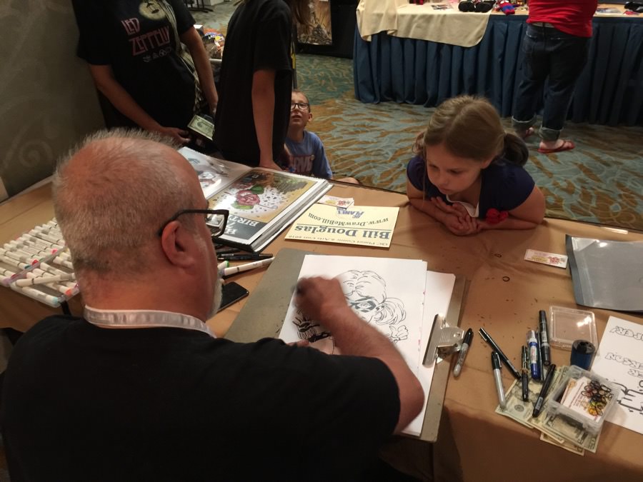Bill Douglas draws a caricature of Sophia Irmen during the Q-C Planet Comics and Arts convention Sunday.