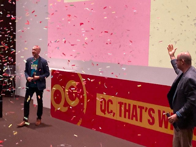 Quad Cities Chamber CEO Paul Rumler, left, and Visit Quad Cities CEO Dave Herrell celebrate the launch of the new campaign with a confetti explosion Thursday at the Figge.