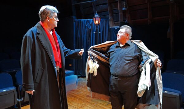 In pursuit of a case, Holmes (Tom Akers) questions a street vendor - bric-a-brac salesman (Samuel Carrington) in "A Sherlock Carol."