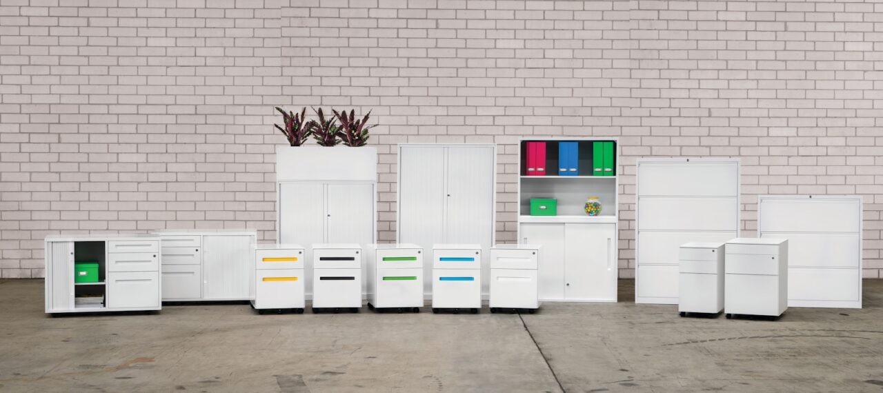 a group of white cabinets sitting next to a brick wall